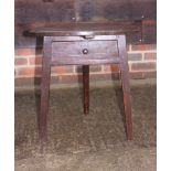 A late 18th century oak cricket table, fitted one drawer, on triangular chamfered supports, 20"