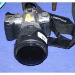 A Pentax MX-5n SLR camera with 28-200 zoom lens