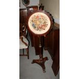 A 19th century rosewood and brass fire screen with circular needlework panel, on tripod splay
