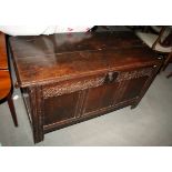 An early 18th century oak triple-panel coffer chest with chip carved panel front and internal candle