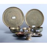 Two Middle Eastern circular brass trays, four brass bowls and three ashtrays