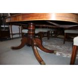 A late Georgian mahogany extending dining table fitted two extra leaves, on twin pedestal and