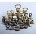 A collection of brass bell-shaped weights, etc