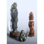An Oriental green soapstone carving of Kuan Yin, 7" high, and two smaller carved African figures