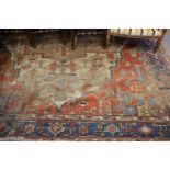 A Kazak rug of geometric design in shades of orange, blue and natural, 118" x 152" approx (worn