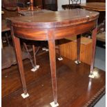 A George III mahogany semicircular fold over top tea table, inlaid stringing, 36" wide