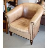 A tub armchair, upholstered in a brown nailed leather