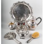 A silver plated on copper three-piece teaset, on tray, together with a dressing table set comprising