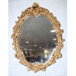 A wall mirror, 37" x 21" overall, in gilt frame