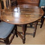 An oval oak drop leaf dining table, on turned underframe, 37" wide