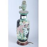 An early 20th century Oriental porcelain famille noire porcelain vase, on wooden base (now converted