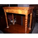 A figured walnut quarter veneered fold-over top card table, on four barley twist supports, 34" wide