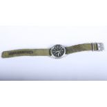 A Seiko military style wristwatch with day and date aperture, Arabic numerals and sweeping hand,