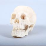 A 19th century carved ivory skull, 1 3/4" high