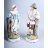 A pair of Continental bisque porcelain figures in Swiss national dress, 15" high (slight damages)