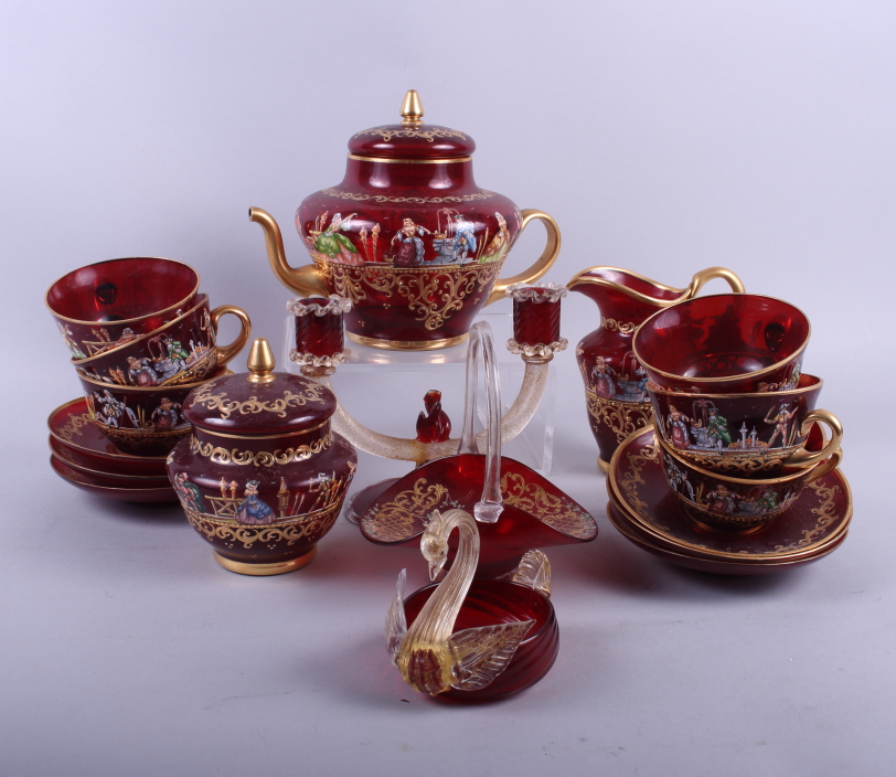 A Continental ruby glass part teaset with enamelled decoration of 18th century figures and gilt