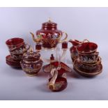 A Continental ruby glass part teaset with enamelled decoration of 18th century figures and gilt