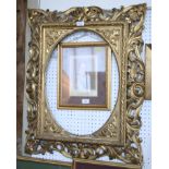 A 19th century gilt picture frame with pierced scroll carved frame and oval mount, 30" x 25"