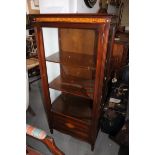A mahogany display cabinet with single glass door and Greek key cornice, on square tapering supports