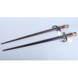 Two late 19th century French bayonets, each with iron scabbards
