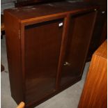 A teak bookcase with adjustable shelves enclosed two glazed doors, 36" wide