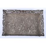 An early 20th century Dutch silver pin tray, embossed with a pub scene, import marks, on four lion