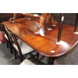 A Bright's of Nettlebed George III design mahogany twin pedestal dining table with centre leaf,