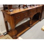 An oak dresser base, fitted three drawers over pot board, on turned supports, 72" wide