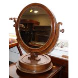 A Victorian mahogany circular swivel dressing table mirror, on circular base