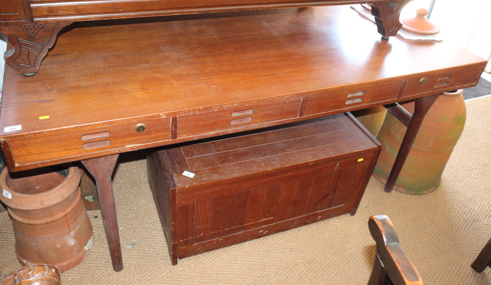 A Nanna Ditzel? teak side table, fitted four drawers, on turned supports, 69" wide