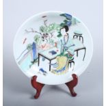 A Chinese porcelain enamelled famille rose saucer dish, decorated with a woman sitting next to a