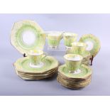 A Paragon part teaset, decorated primroses, and assorted decorative plates