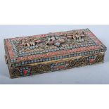 A gilt metal Nepalese trinket box with relief decoration, 7 1/2" wide