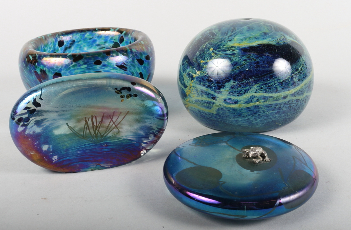 Two John Ditchfield Glasform paperweights, one decorated frog on a lily pad, and two other pieces of