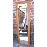 A pine framed wall mirror, 72" x 44" overall