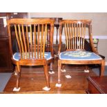 A pair of Edwardian inlaid rosewood open arm nursing chairs, the seats upholstered in a floral