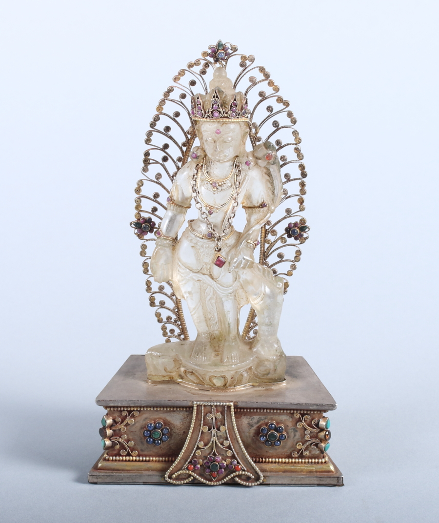 A 19th/early 20th century carved rock crystal deity with applied yellow metal and stone