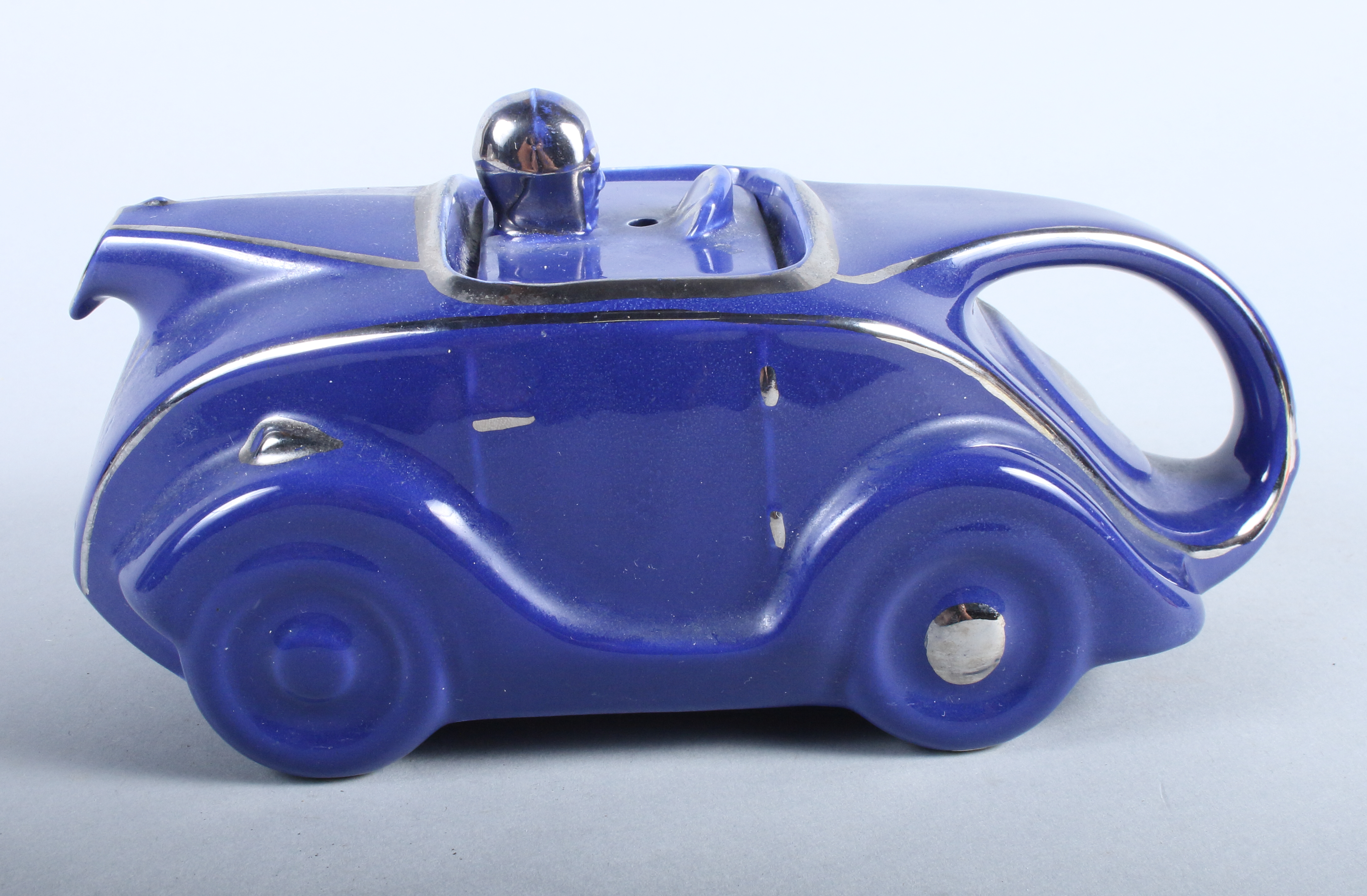 A 1930s Stabler design blue glazed racing car teapot, 9" long