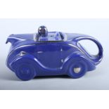 A 1930s Stabler design blue glazed racing car teapot, 9" long