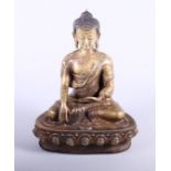 A late 19th/early 20th century Chinese / Tibetan gilt brass seated Buddha on a lotus leaf, bearing