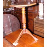 An early 19th century mahogany octagonal tilt top occasional table, on turned column and tripod