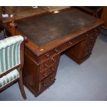 A late 19th century walnut double pedestal desk with tooled lined top, fitted nine drawers, on block