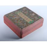 A Chinese lacquer box, decorated with red silk string, objects and characters, together with an