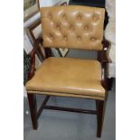 A polished as mahogany open armchair, upholstered in a cream simulated leather, on square supports