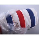 A roll of red, white and blue striped fabric, 55" wide approx