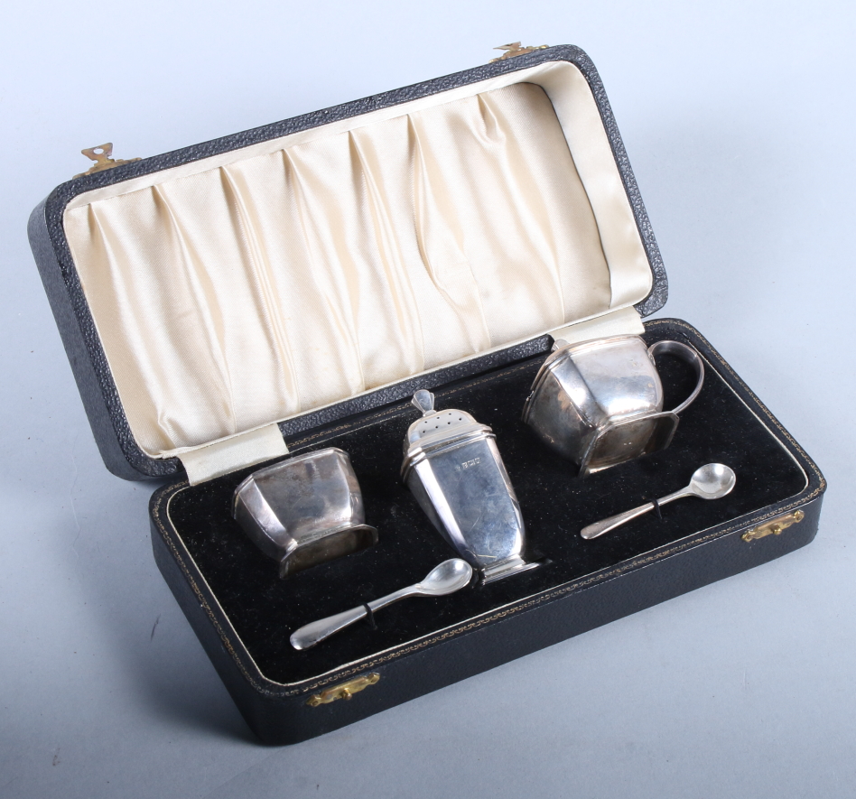 A matched three-piece silver cruet set and two mustard spoons, in fitted box
