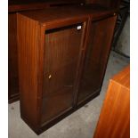 A teak bookcase with adjustable shelves enclosed two glazed doors, 36" wide
