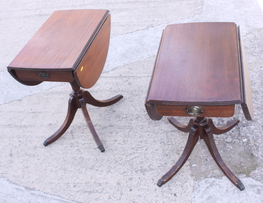 A pair of mahogany drop leaf tables, on turned column and quadruple splay supports, and a circular