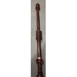 A 19th century mahogany curtain pole, 60" long