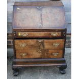 A figured walnut fall front bureau, fitted three drawers, on scroll supports, 27" wide